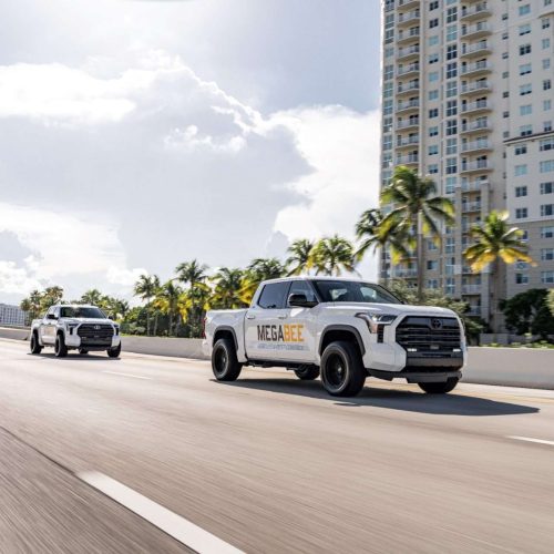 megabee-trucks-driving-highway-city-north-miami